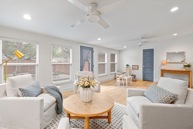 living area with recessed lighting, light wood finished floors, baseboards, and ceiling fan