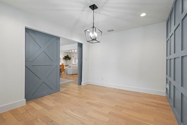 unfurnished dining area with baseboards, visible vents, and a chandelier