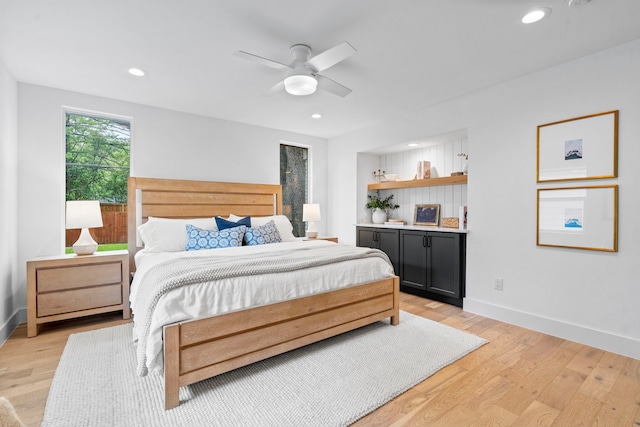 bedroom with recessed lighting, baseboards, a ceiling fan, and light wood-style flooring