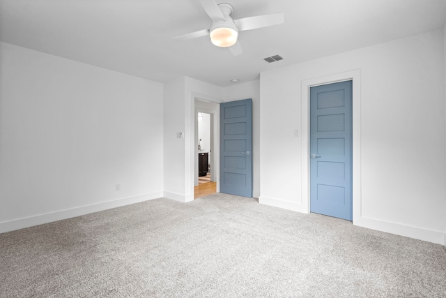 unfurnished bedroom featuring ceiling fan, baseboards, visible vents, and carpet