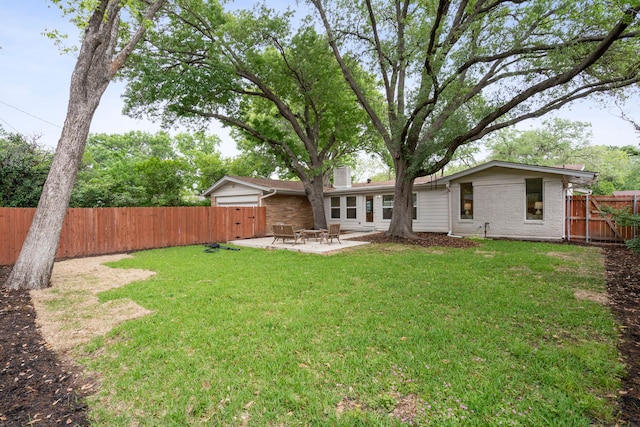 view of yard with a fenced backyard and a patio