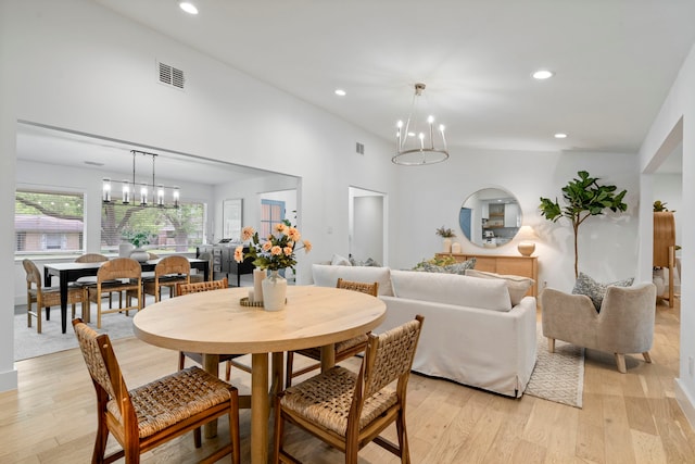 dining space featuring a chandelier, light wood-type flooring, visible vents, and recessed lighting