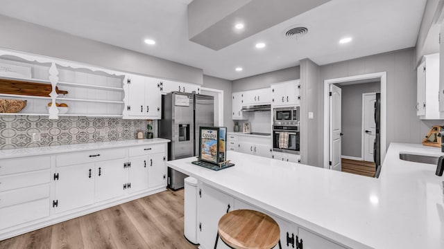 kitchen with visible vents, stainless steel appliances, open shelves, a sink, and under cabinet range hood