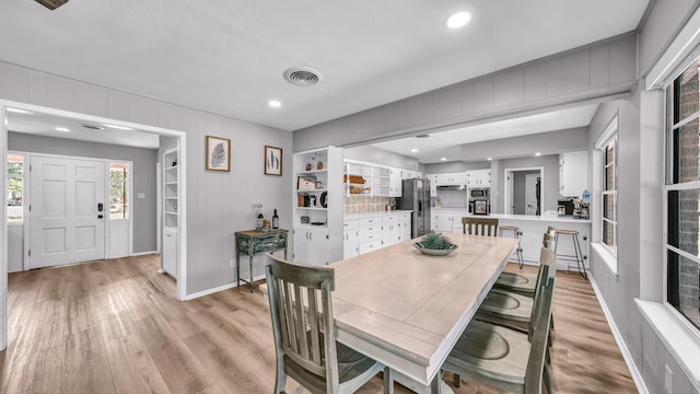 dining room featuring recessed lighting, baseboards, light wood-type flooring, and visible vents