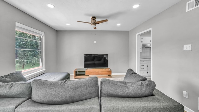living room featuring baseboards, a ceiling fan, recessed lighting, and visible vents