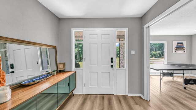 entrance foyer featuring baseboards and light wood-style floors