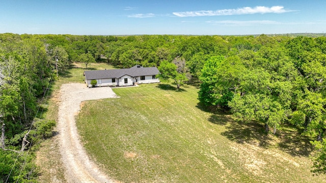 birds eye view of property featuring a view of trees