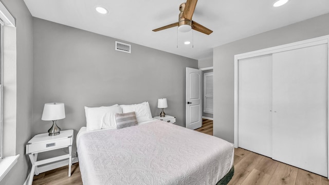 bedroom with visible vents, a closet, wood finished floors, ceiling fan, and recessed lighting