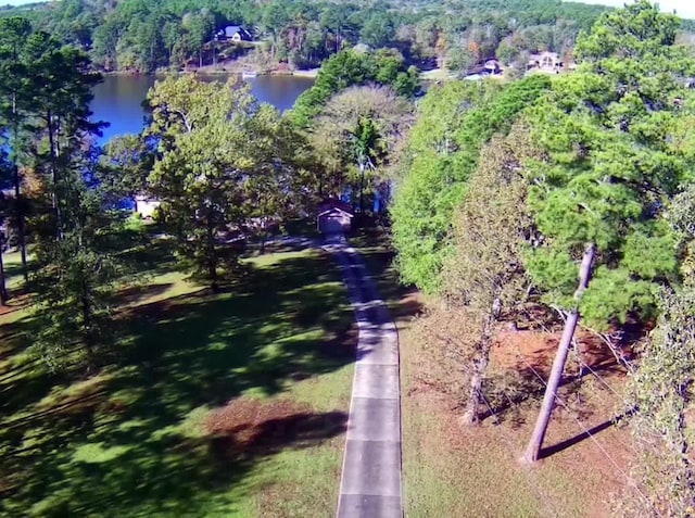 drone / aerial view with a water view and a wooded view