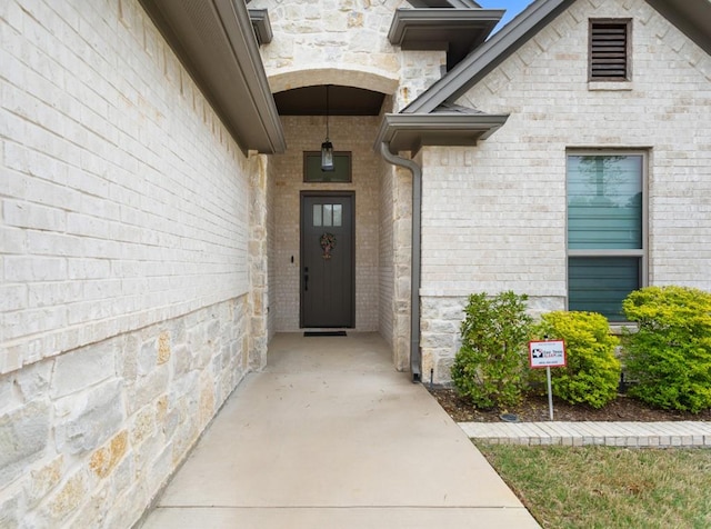 entrance to property with brick siding and stone siding