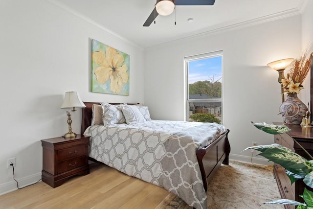 bedroom with light wood-type flooring, crown molding, baseboards, and ceiling fan