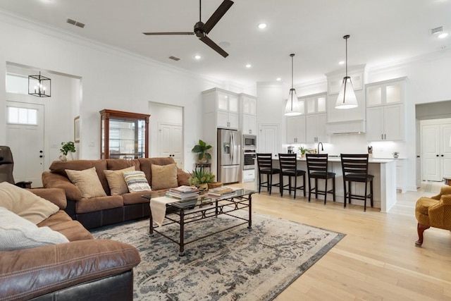 living room with crown molding and visible vents