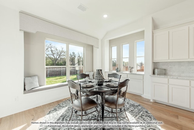dining area featuring recessed lighting, lofted ceiling, visible vents, and light wood-style flooring