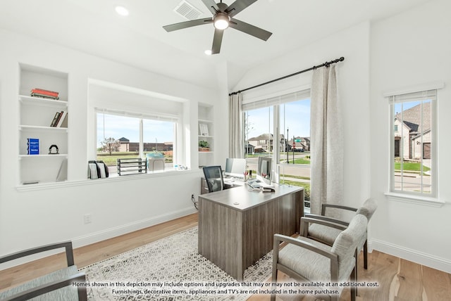 office space with wood finished floors, visible vents, a ceiling fan, and baseboards