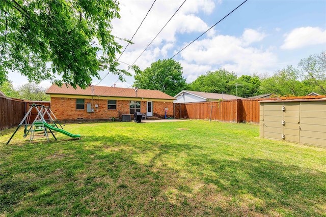 view of yard with a fenced backyard, an outdoor structure, central air condition unit, and a storage shed