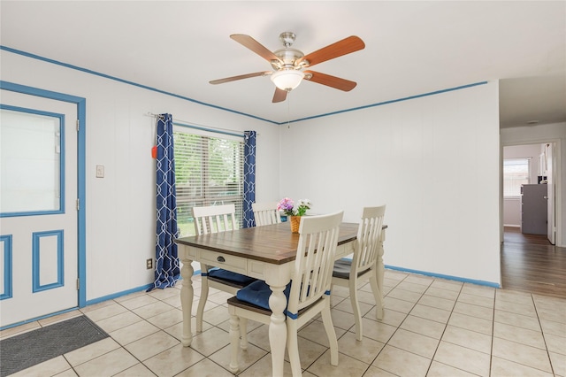 dining room with light tile patterned flooring, baseboards, and ceiling fan