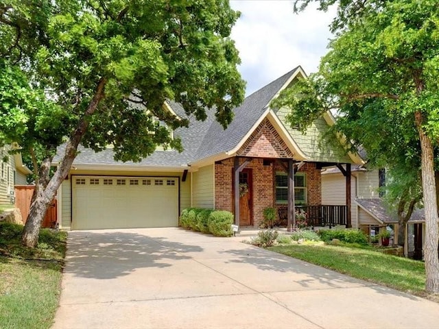 view of front of home with a garage, a shingled roof, brick siding, and concrete driveway