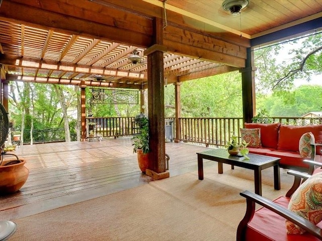 wooden deck featuring a pergola and an outdoor hangout area