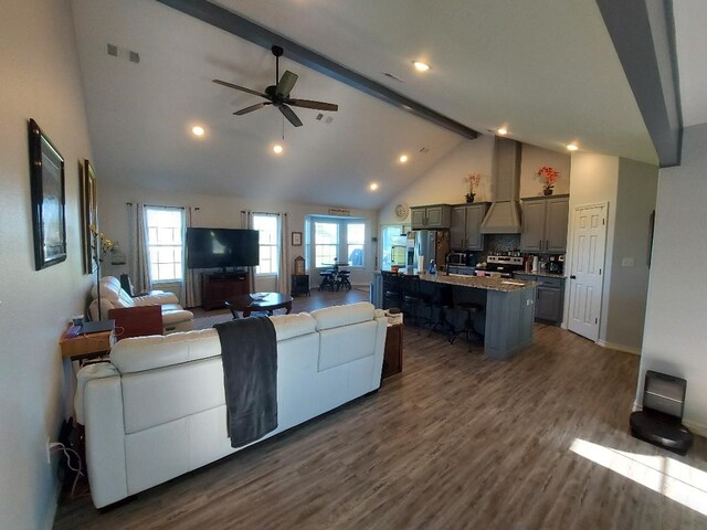 35 County Road 2342, Sulphur Springs, TX 75482 - living room featuring dark wood-style floors, visible vents, beamed ceiling, ceiling fan, and high vaulted ceiling