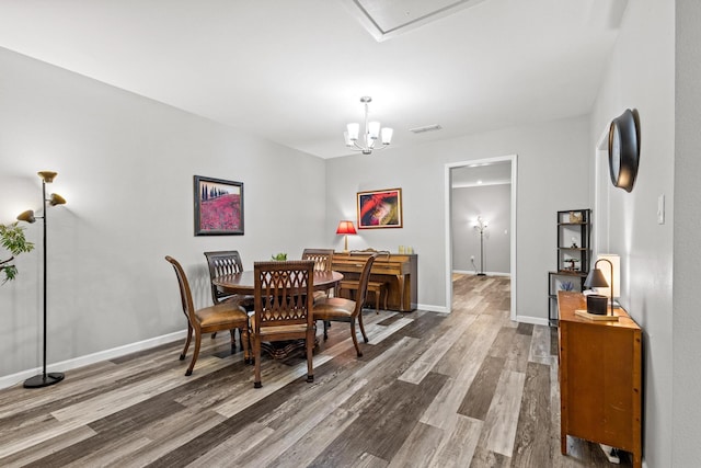1425 E Cherry, Sherman, TX 75090 - dining area featuring baseboards, wood finished floors, visible vents, and an inviting chandelier