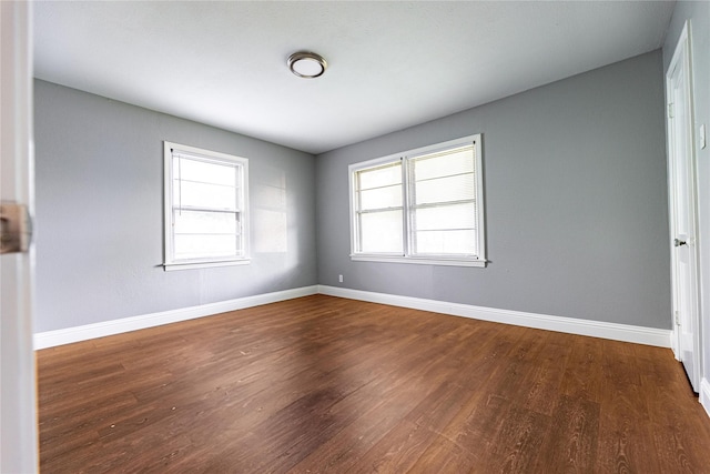 3143 Grayson Dr, Dallas, TX 75224 - empty room featuring dark wood-type flooring and baseboards