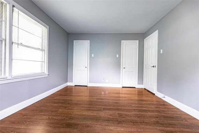 3143 Grayson Dr, Dallas, TX 75224 - unfurnished bedroom featuring wood finished floors and baseboards