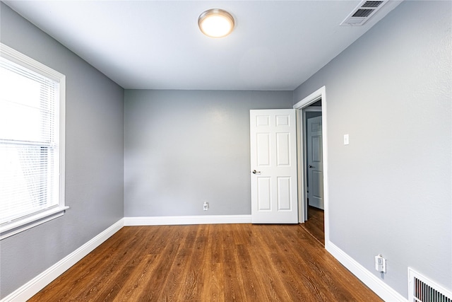 3143 Grayson Dr, Dallas, TX 75224 - spare room featuring wood finished floors and baseboards