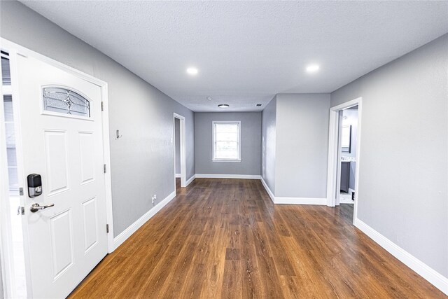 3143 Grayson Dr, Dallas, TX 75224 - foyer entrance featuring wood finished floors, baseboards, recessed lighting, and a textured ceiling