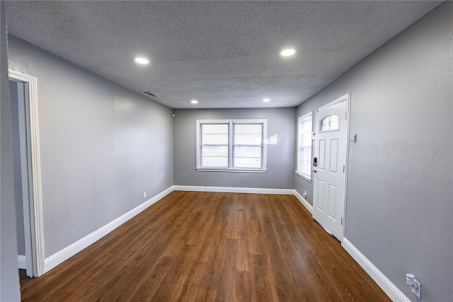 3143 Grayson Dr, Dallas, TX 75224 - entryway featuring dark wood finished floors, a textured ceiling, recessed lighting, and baseboards