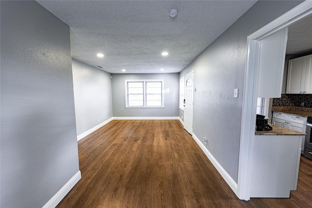 3143 Grayson Dr, Dallas, TX 75224 - hallway with dark wood-type flooring, a textured ceiling, baseboards, a textured wall, and recessed lighting