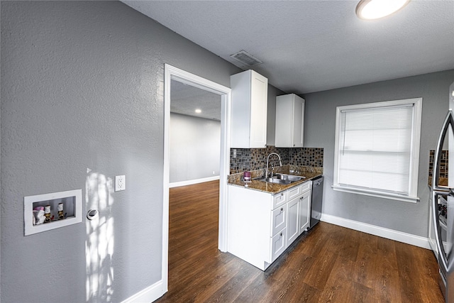 3143 Grayson Dr, Dallas, TX 75224 - kitchen featuring a sink, dishwasher, baseboards, tasteful backsplash, and white cabinetry