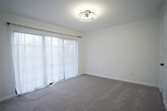 unfurnished bedroom featuring carpet floors and baseboards