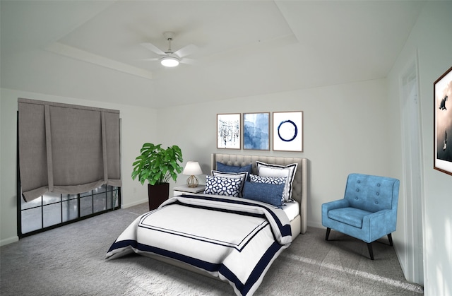 carpeted bedroom featuring a tray ceiling, baseboards, and ceiling fan