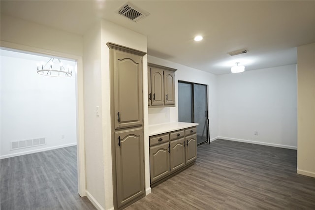kitchen featuring dark wood-type flooring and visible vents
