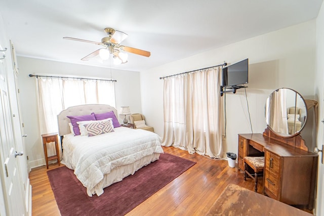 bedroom with a ceiling fan and wood finished floors