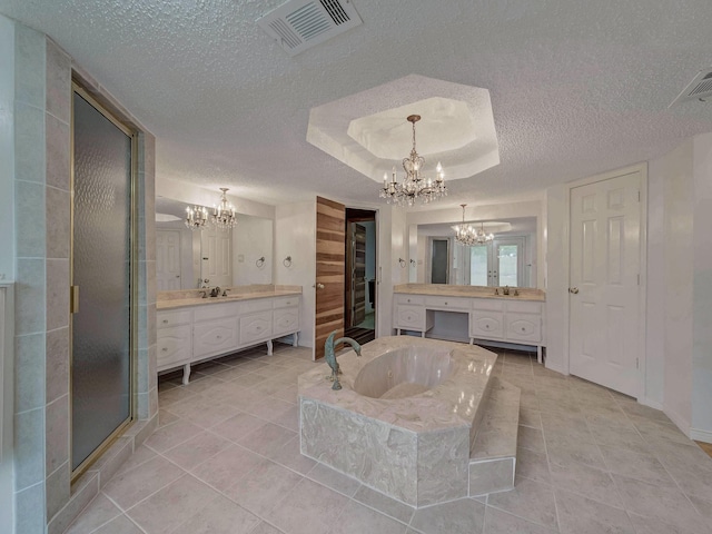 907 Red Oak Creek Dr, Ovilla, TX 75154 - bathroom featuring a chandelier, a textured ceiling, two vanities, and tile patterned floors