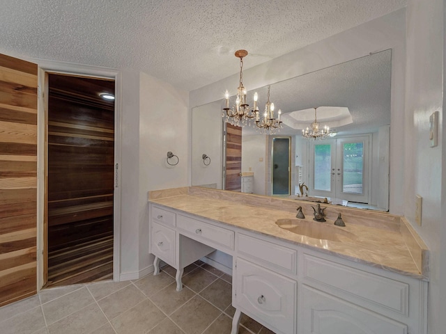 907 Red Oak Creek Dr, Ovilla, TX 75154 - bathroom with a textured ceiling, a chandelier, tile patterned floors, and vanity