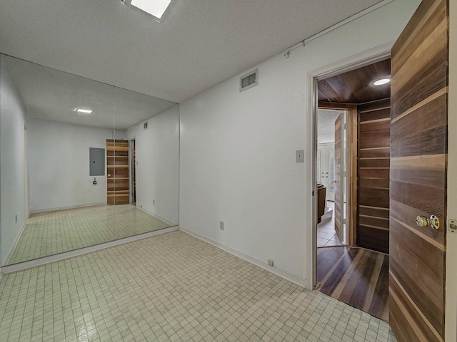 907 Red Oak Creek Dr, Ovilla, TX 75154 - spare room featuring baseboards, a textured ceiling, and electric panel