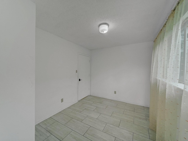 907 Red Oak Creek Dr, Ovilla, TX 75154 - spare room featuring a textured ceiling