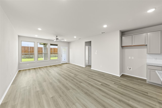 473 Silent Pond Park, Lavon, TX 75166 - unfurnished living room featuring baseboards, a ceiling fan, visible vents, and light wood-style floors