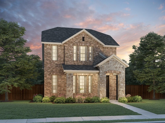 2744 Amistad Ln, Corinth, TX 76210 - traditional home featuring brick siding, a front lawn, roof with shingles, and fence