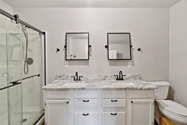 full bathroom featuring toilet, a sink, double vanity, and a stall shower