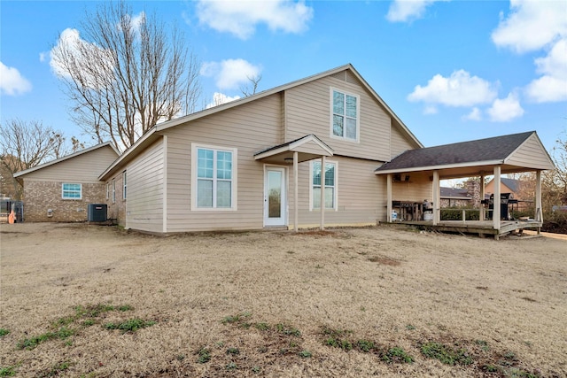 rear view of house with central AC and a wooden deck
