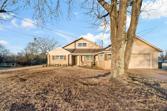view of front of home with concrete driveway, brick siding, covered porch, and a garage
