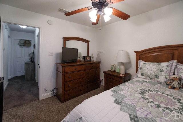 bedroom featuring dark carpet, baseboards, a ceiling fan, and visible vents