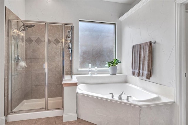 bathroom with a shower stall, a garden tub, and tile patterned floors