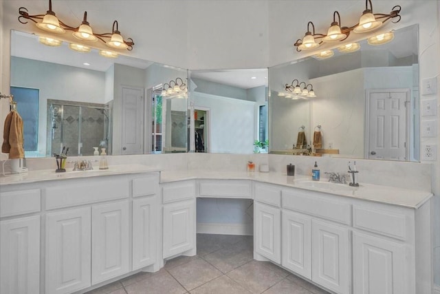 bathroom featuring vanity, a shower stall, tile patterned flooring, and a chandelier