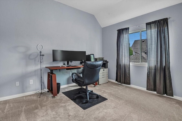 home office featuring lofted ceiling, baseboards, and carpet flooring