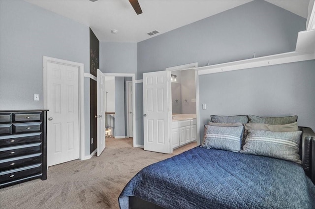 carpeted bedroom with ensuite bath, visible vents, and a ceiling fan
