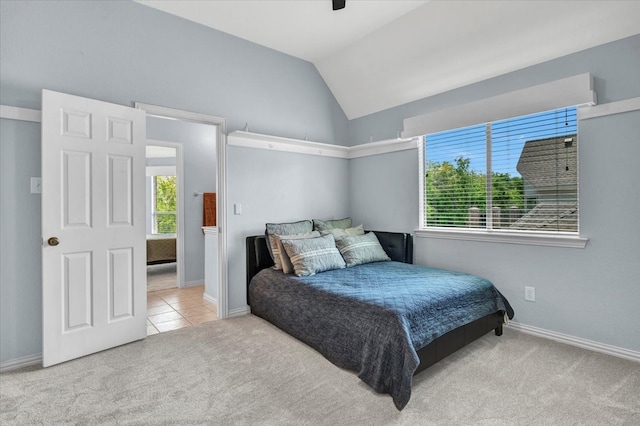 bedroom with lofted ceiling, tile patterned floors, a ceiling fan, baseboards, and carpet flooring